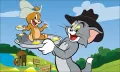 Kocour Tom a myška Jerry v kovbojských kloboucích hledají zlato u potoka, zelená krajina, jedlý obrázek na dort