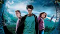 Harry, Ron a Hermiona před bradavickým hradem s letícím hipogryfem Klofanem na tmavém pozadí, jedlý obrázek na dort