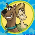 Scooby Doo a Shaggy ve žlutém oválu na modrém vzorovaném pozadí, jedlý obrázek na dort