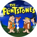Kulatý jedlý obrázek na dort: Fred, Wilma, Barney a Betty z Flinstoneových na noční obloze s měsícem a palmami, nad nimi žlutý nápis