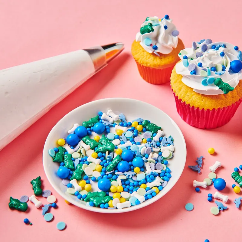 Cukrové zdobení Wilton ve tvaru 3D dinosaurů a kostí, mix 70 g na dort a muffiny